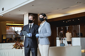 Hotel employee working in team while guests arriving
