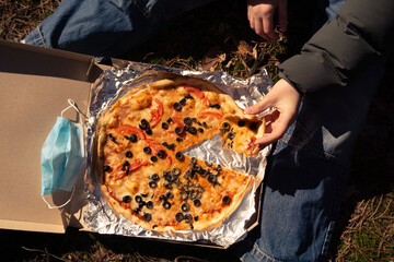 Delicious snack with fresh margarita pizza on a sunny day in the woods.