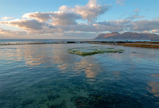 Dawn sunrise reflections over Dale Brook Tide Pool in Cape Town South Africa RSA