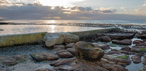 Rock jetty seawall at Dale Brook tidal swimming pool at Cape Town South Africa RSA