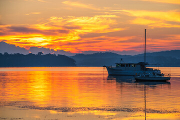Sunrise waterscape with boats and soft colour
