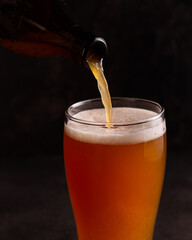 Beer is poured into a glass