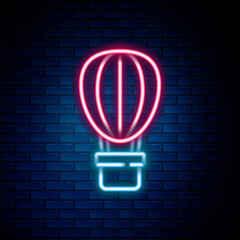 Obraz premium Glowing neon line Hot air balloon icon isolated on brick wall background. Air transport for travel. Colorful outline concept. Vector