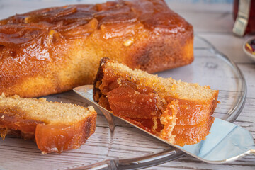 Home made apple cake and a slice of cake on silver service spatula