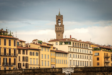 Florence cityscape with the Santa Trinita Bridge (XVI century) over the River Arno and the clock tower of Palazzo Vecchio (1299) called Torre di Arnolfo, UNESCO world heritage site, Tuscany, Italy.