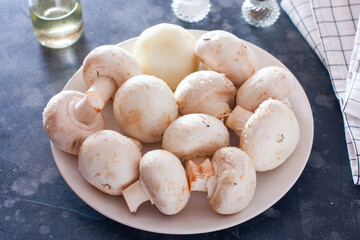 raw mushrooms on a white plate, ingredients for cooking, horizontal