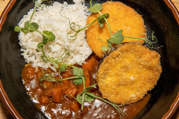 A delicious vegetarian meal of Aubergine Eggplant Katsu Curry with white fluffy rice