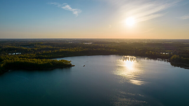 Stunning aerial drone landscape image of sunset or sunrise in spring over Europese countryside. High quality photo