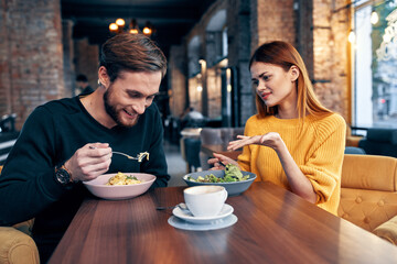 man and woman sitting in a cafe communication snack lifestyle romance