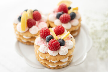 selection of sweet baked cream edible flowers and fruit dessert cakes for mothersday, wedding, birthday, paerty celebration. viola odorata cake. 