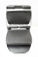 electric grill with open lid. appliance for cooking in everyday life. Made of stainless steel, special non-stick coating. healthy food. food without oil and fat. 