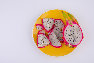 Dragon fruit on plate isolated on white background