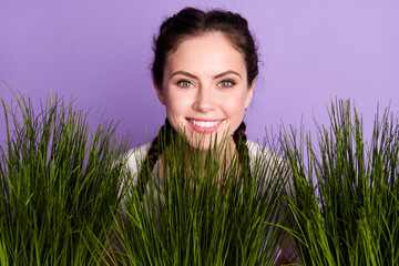 Photo of positive happy nice young woman good mood smile grass green garden isolated on purple color background