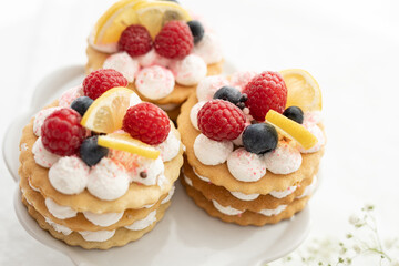selection of sweet baked cream edible flowers and fruit dessert cakes for mothersday, wedding, birthday, paerty celebration. viola odorata cake. 