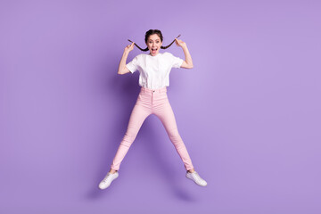 Fototapeta na wymiar Full length photo of young attractive girl happy positive smile jump up isolated over violet color background
