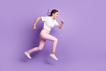 Full body profile side photo of young attractive girl happy positive smile jump run hurry isolated over violet color background