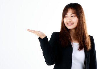 Young and fresh new graduated look Asian businesswoman in black suit show hand palm to present or demonstrate goods and product in advertising gesture on white background