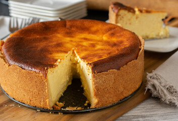 homemade fresh baked german cheesecake on wooden table background