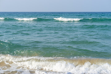 Fototapeta na wymiar Waves Crash on a Beach
