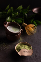 Cups of green matcha tea with milk