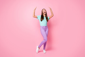 Full size photo of young happy excited good mood woman dancing raise hands up isolated on pink color background