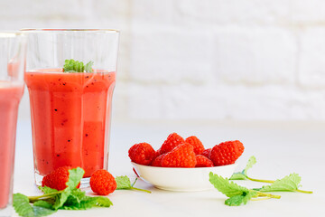glass with red smoothie. Healthy eating and sustainability. Smoothie made from raspberries and other red fruits. Zero waste