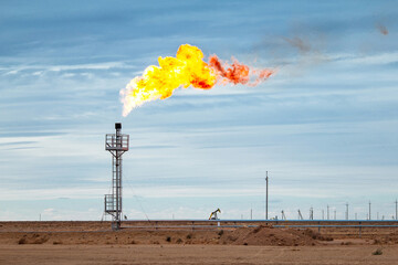 Industrial gas torch on the background of blue cloudy sky