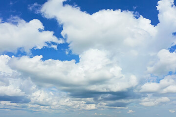 Obraz na płótnie Canvas white clouds on blue sky background, abstract seasonal wallpaper, sunny day atmosphere