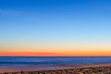 Clear gradient sky at sunset over the sea - 430958843