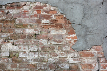 old brick wall with peeling plaster, abstract background, texture