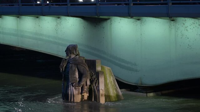 Floodings in paris at dusk - illuminated The Zouave statue, half-submerged by floodwaters as river Seine continues to rise in central Paris France 