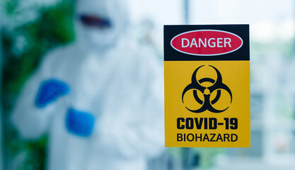 Warning sign on wall of coronavirus research lab