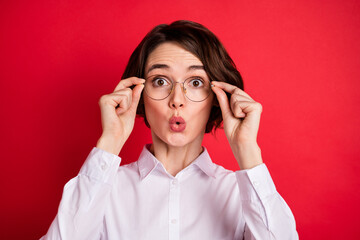 Photo portrait of amazed business woman wearing glasses white shirt staring isolated vivid red color background
