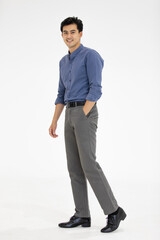 Full body Portrait of Asian businessman in casual business clothes wearing a shirt and slack trousers posing on white background.