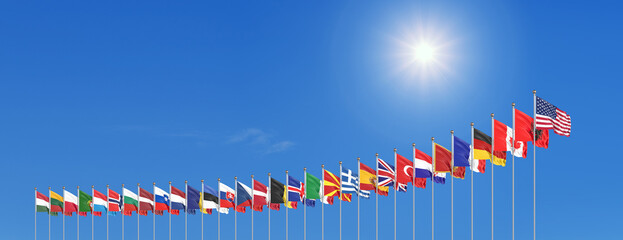 The 30 waving Flags of NATO Countries - North Atlantic Treaty. Isolated on sky background  - 3D illustration.