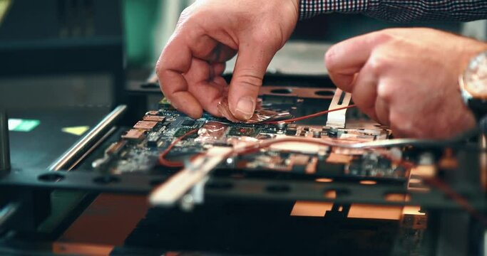 Placing thermo-aluminum foil on the motherboard. Concept of preparing the circuit board for heating and removing the micro chip. Processor removal machine