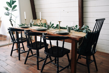 Close-up celebratory table, empty glasses set in home kitchen, family holidays celebration 