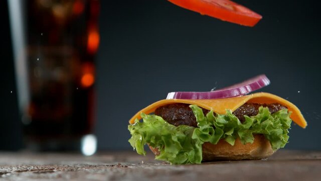 Super slow motion of stacking cheeseburger pieces. Filmed on high speed cinema camera, 1000 fps.