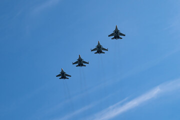 fighter jets in the blue sky. rehearsal of the victory parade. military action, bombing. Airshow.