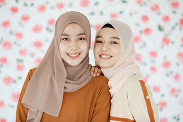 Portrait of young and beautiful two Asian Muslim women taking photo together.