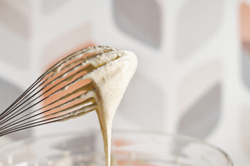 Whisk the cake mixture. Whisk in a bowl close-up