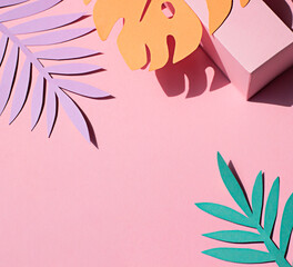 Fototapeta na wymiar Hand cut paper tropical plants leaves on the pink background. Summer concept Top view. Copy space