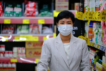 Asian women wear masks to prevent contagious diseases during the epidemic while shopping in department stores.