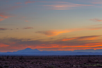 Orange clouds and blue mountains at sunset in the Karoo
