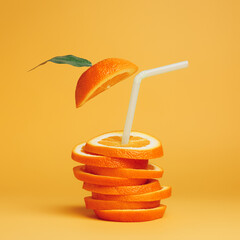 Summer composition with fresh stacked orange slices and straw on vibrant orange background....