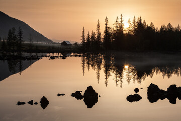 Sunrise at lake in mountain range. Beautiful reflection in water - 430970641