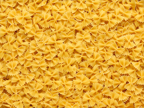 Macro image of many Italian pasta in the form of bows.