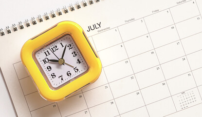 Yellow clock on top of calendar.