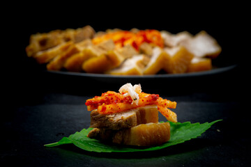 Bossam, boiled pork is eaten with spicy radish and Salted shrimp