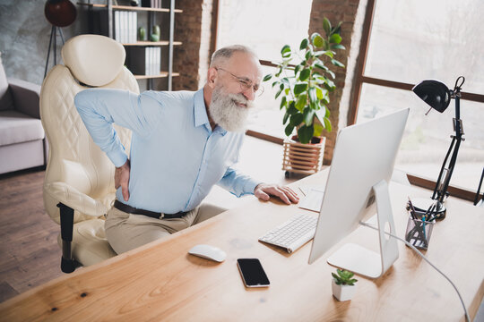 Portrait Of Attractive Overworked Tired Sick Man Feeling Bad Touching Back Health Care At Brick Loft Industrial Office Indoor